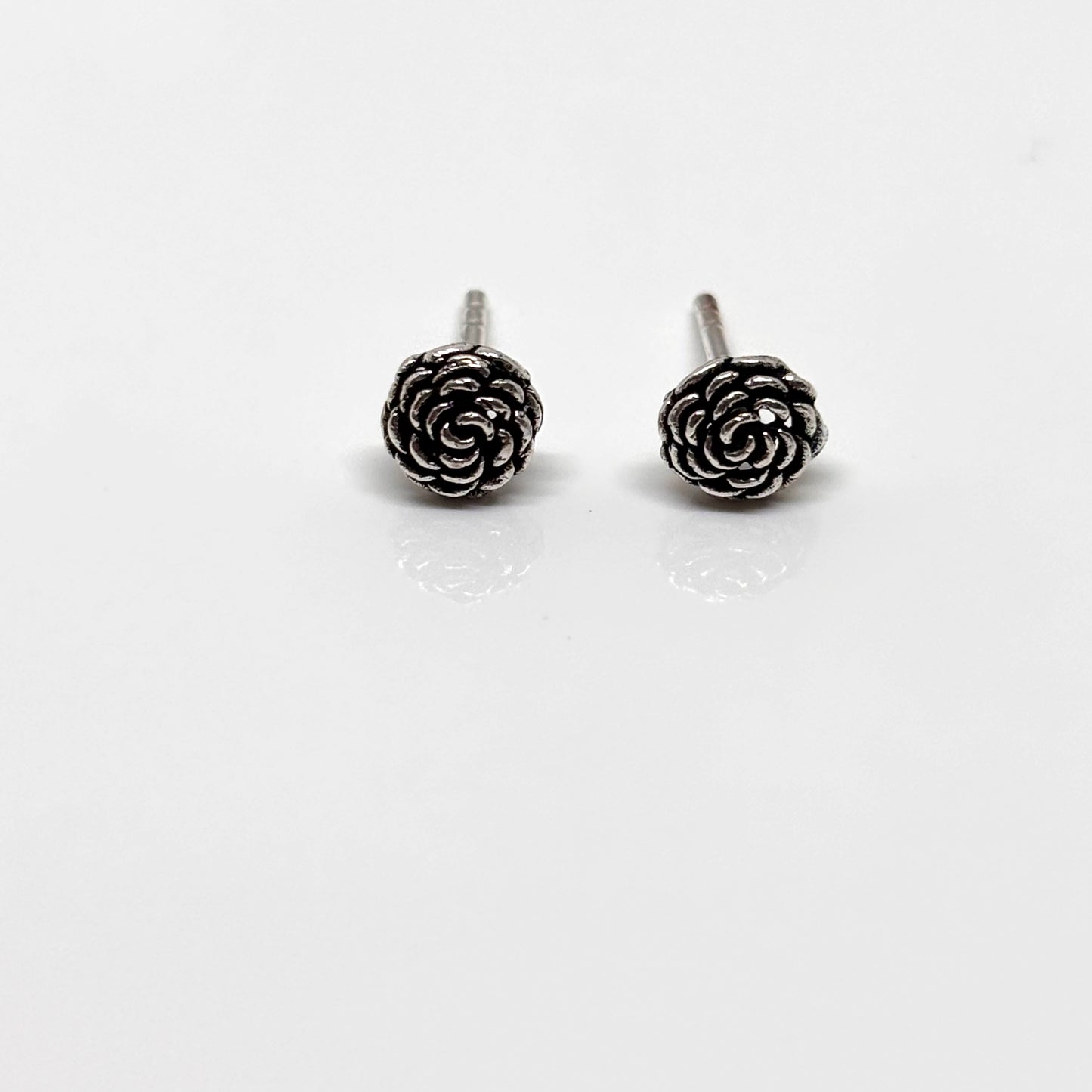 Pair of silver rose-shaped earrings from Pixi Daisy