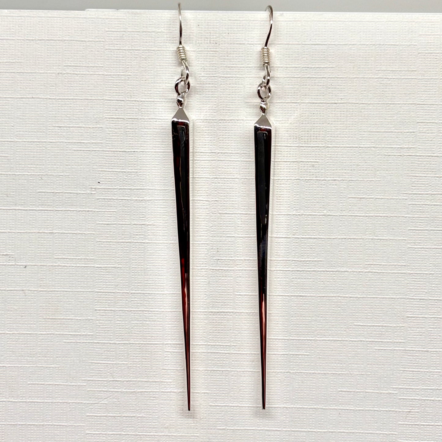 Long, thin silver pointed earrings from Pixi Daisy