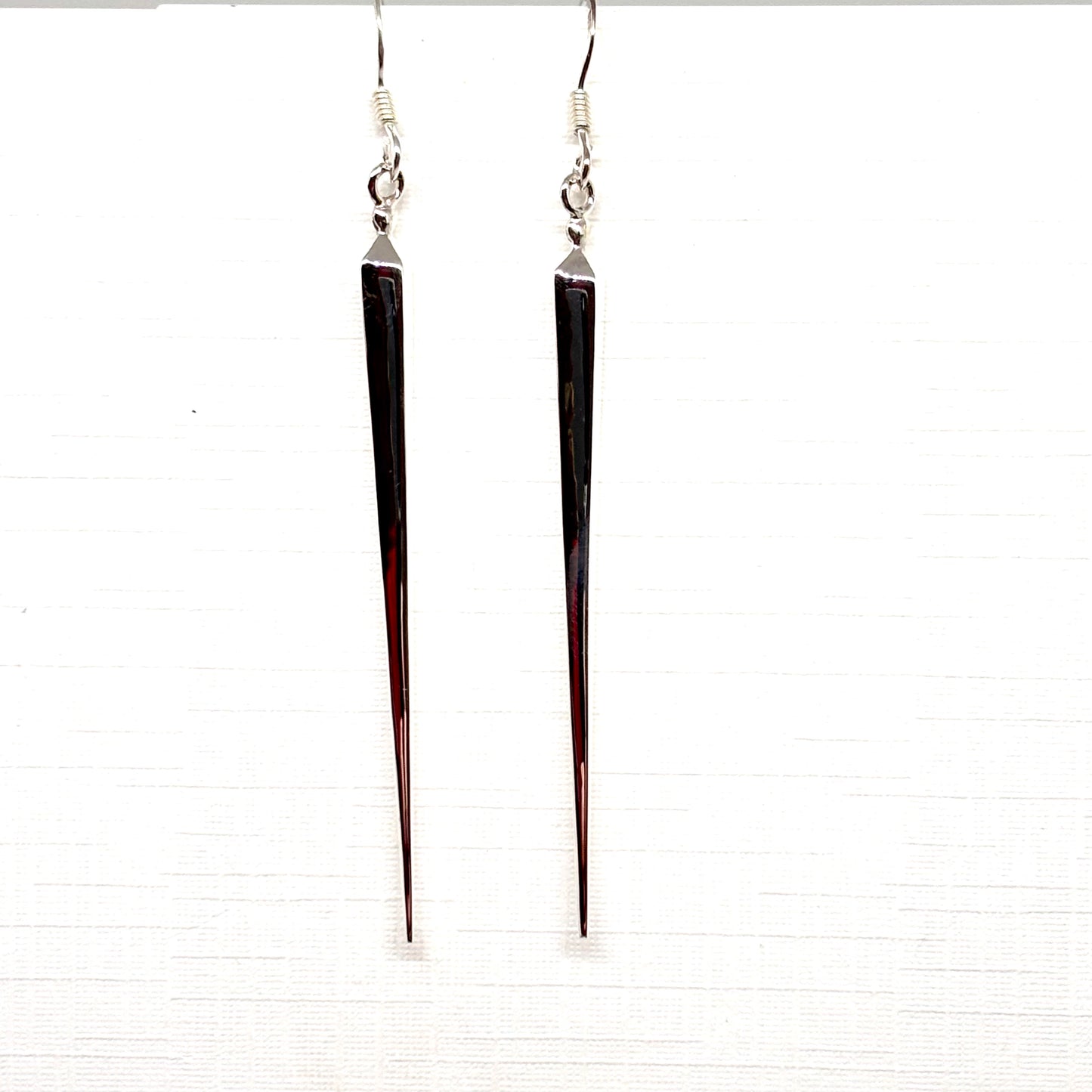 Long, thin silver pointed earrings from Pixi Daisy
