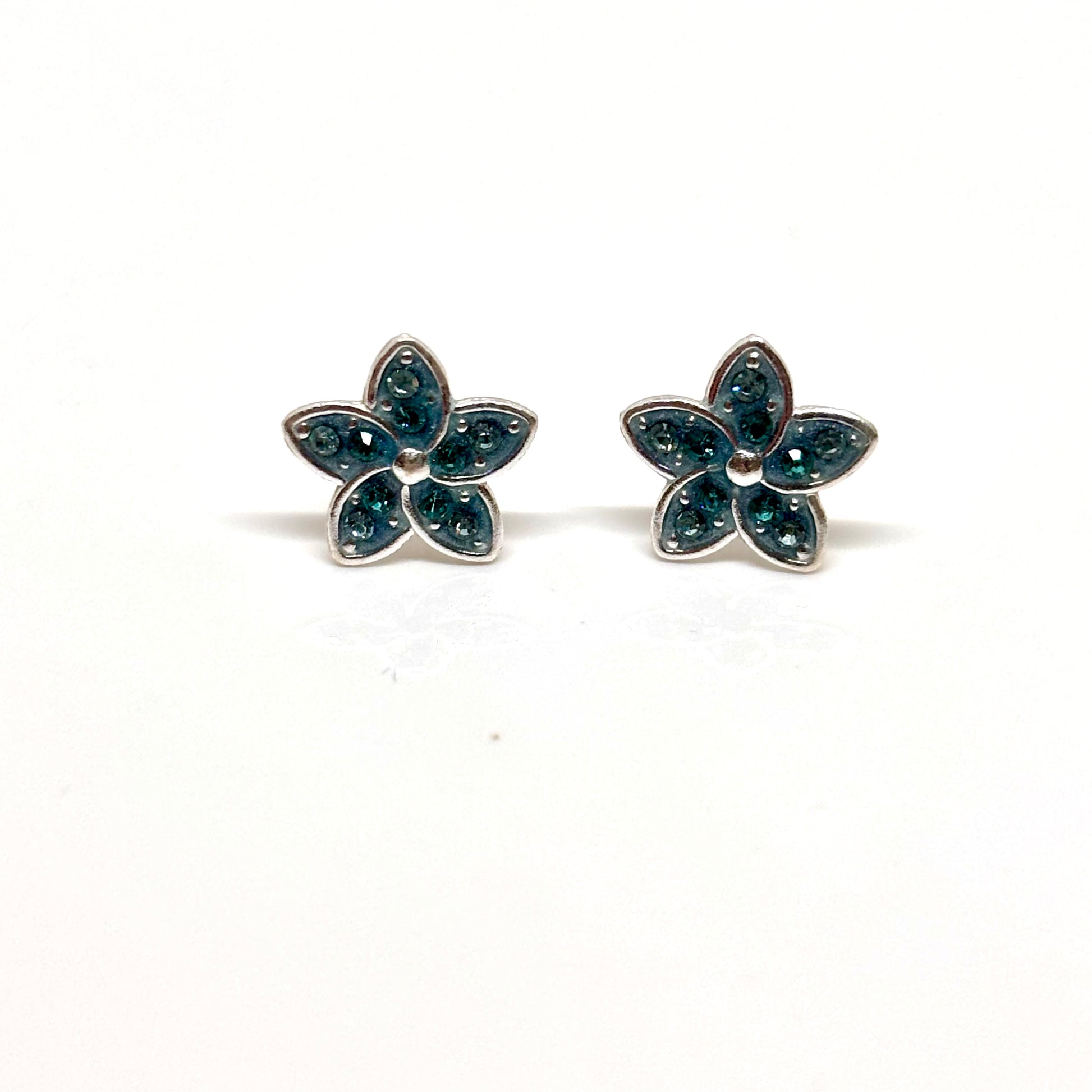 Pair of flower-shaped earrings with light blue gemstones from Pixi Daisy