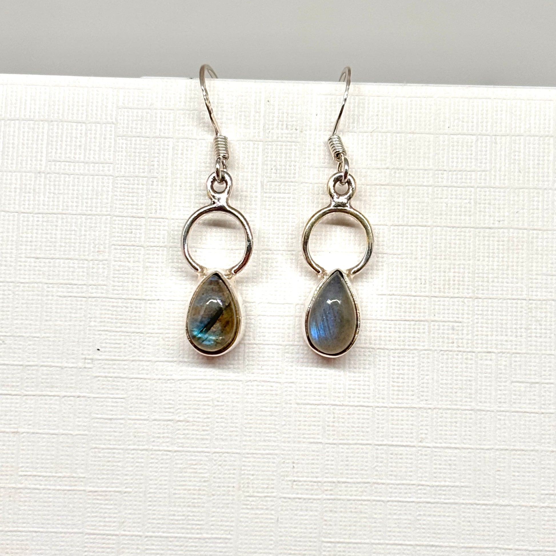 Pair of silver opalite dangly earrings within a teardrop shape