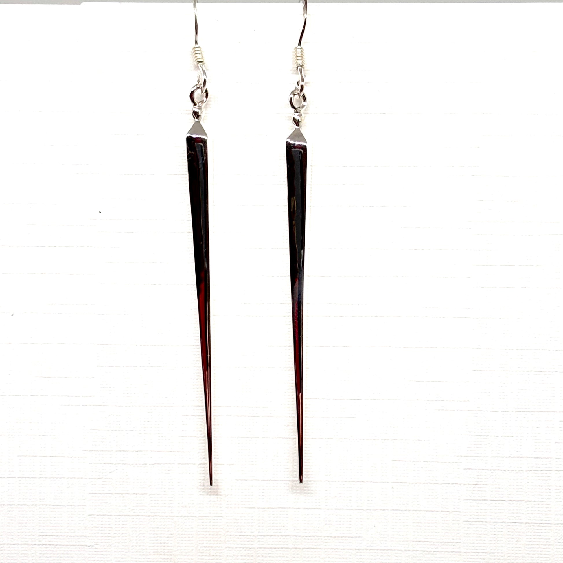 Long, thin silver pointed earrings from Pixi Daisy