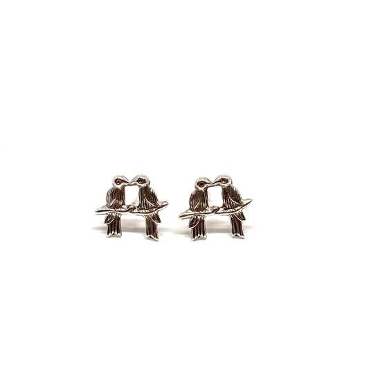 Pair of silver bird-shaped earrings on a branch from Pixi Daisy